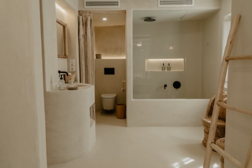 Salle de bain moderne avec douche à l'italienne, baignoire balnéo, accents bois et éclairage ambiant à EntreArcos Casa Eco-Boutique