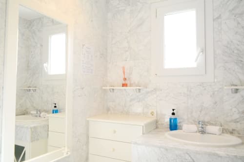 Marble bathroom at Royal Banus Marbella with dual sinks, corner tub, and modern fixtures