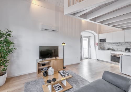 Modern duplex apartment at Oporto Comfort Dom Hugo in Porto with open-plan living, kitchen, and city views