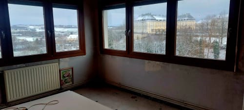 Empty room with panoramic windows overlooking Champlitte countryside at Les Hortensias B&B
