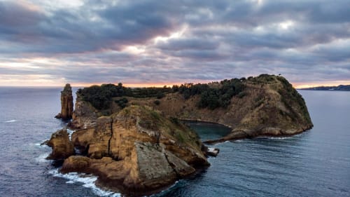 Dramatic rocky islands and coastal cliffs at sunset near Golden Mermaid Villa, Ribeirinha Portugal