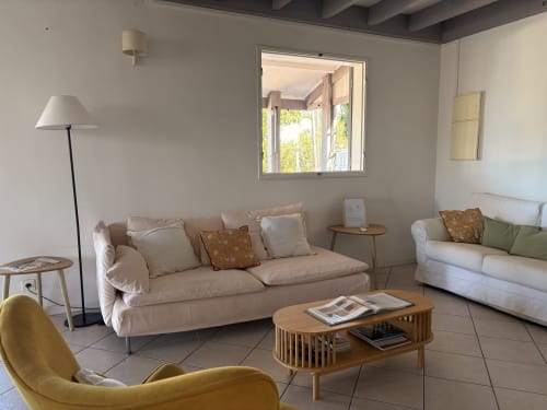 Spacious villa living room at La Villa Maraloupia with comfortable seating, wooden coffee table, and sea views through large