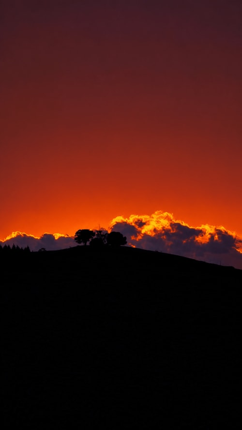 Atardecer dramático sobre la costa de Mutriku con colinas silueteadas y nubes doradas en el hotel MATZURI