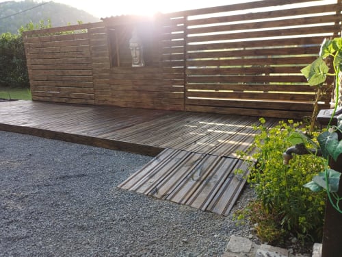 Wooden deck and fencing at Le gite des mousquetaires cottage in Lanne en Baretous, with mountain views and garden plants
