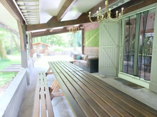 Covered patio with wooden bench at Le gite des mousquetaires BnB in Lanne en Baretous, France