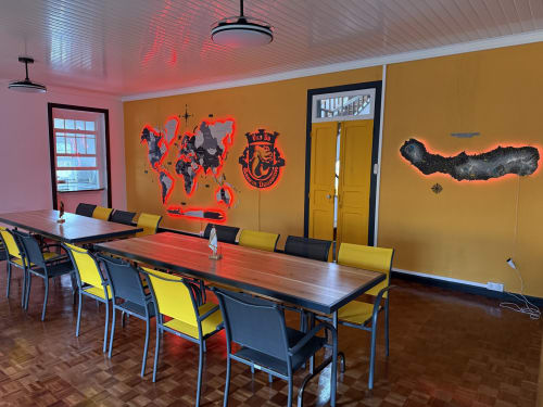 Modern meeting room at Golden Mermaid Villa with yellow chairs, world map art, and vibrant decor in Ribeirinha