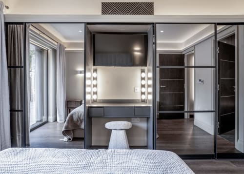 Modern bedroom suite at The Coach House, 100 Banbury Road Oxford, featuring ensuite with illuminated vanity mirror and garden