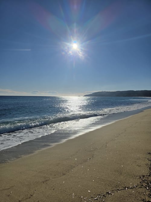 Pristine sandy beach with turquoise waves and bright sunshine, Saint-Tropez coast view from Hôtel Les Lauriers