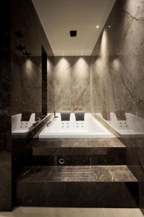 Lussuosa spa con vasca idromassaggio incassata, pareti in marmo e illuminazione ambientale presso Donna Filomena