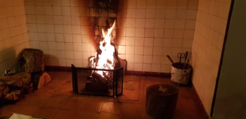 Cozy fireplace with burning wood at Herdade Do Vidigal, Montemor-o-Novo, Portugal