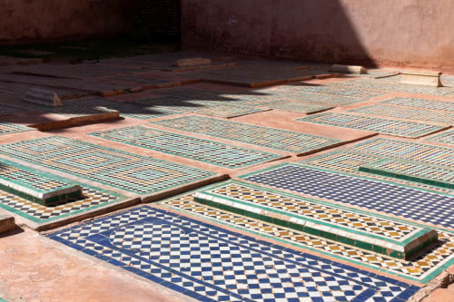 Traditional zellige tile courtyard at Riad Casa Angelo in Marrakech, featuring geometric blue and green patterns