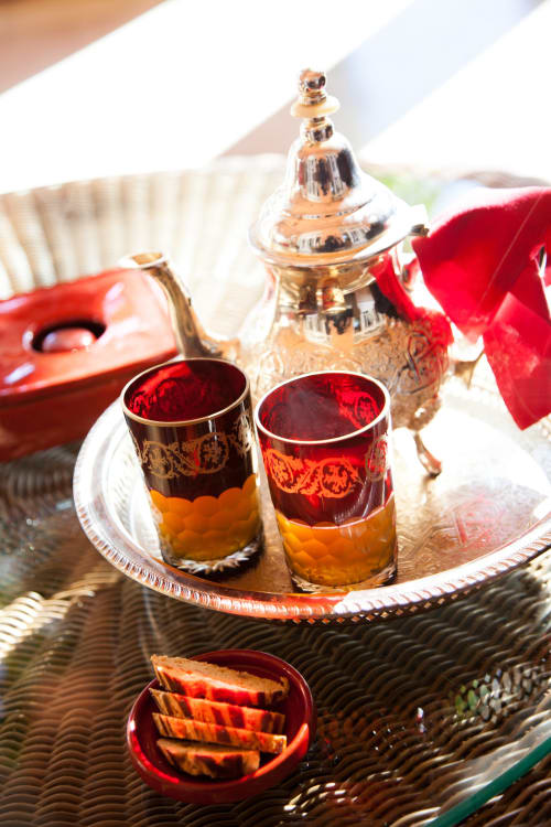 Traditional Moroccan tea service at Riad Casa Angelo, Marrakech with ornate glasses and teapot
