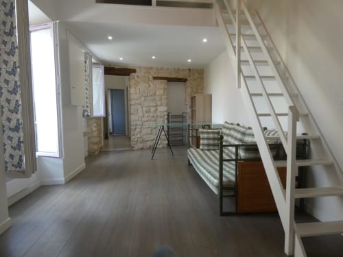 Appartement spacieux à Nanterre avec mezzanine, parquet, murs en pierre, escaliers et équipements modernes à l'hôtel Sci Ludji