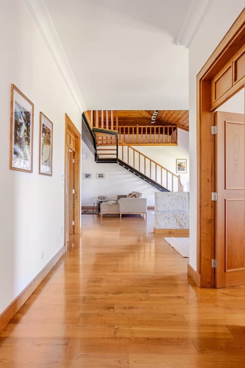 Spacious hallway with wooden doors and hardwood flooring in Casa dos Vasconcelos cottage, Chaves