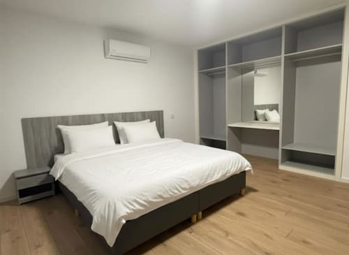 Modern bedroom at Casa dos Vasconcelos, Chaves Portugal with queen bed, built-in wardrobe, air conditioning and wooden floors