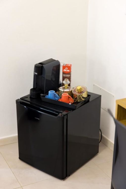 Caffettiera e stazione di ristoro sul minibar nella camera del bed and breakfast La Maison Du Lion a La Spezia