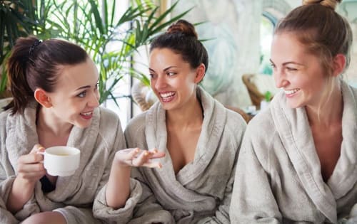 Three women in spa robes enjoying tea and conversation at The Lavender House hotel in Foulsham