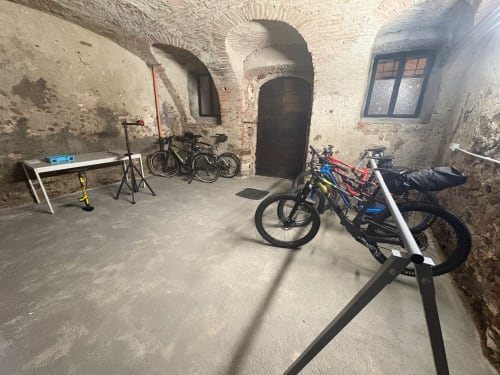 Area parcheggio biciclette presso la Residenza Basiglio a Ceva con bici su supporti e attrezzi di riparazione