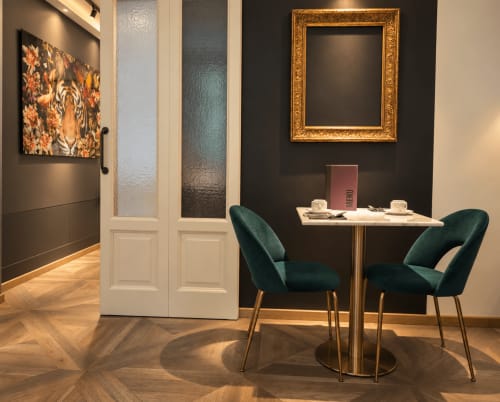 Elegante sala riunioni di Porta Tosa Milano B&B con sedie turchesi, tavolo in marmo e parete scura