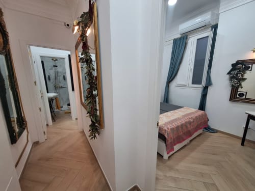 Luxury Room at Salamanca Luxury Rooms Madrid with bed, hallway, bathroom entrance, and modern amenities