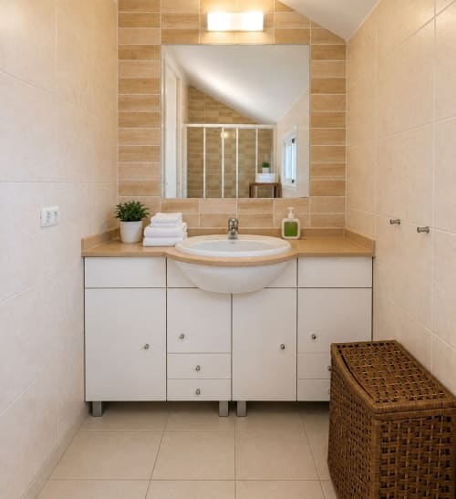 Modern bathroom with vanity sink, white cabinetry, wood countertop, and large mirror in Manage Home Tenerife apartment