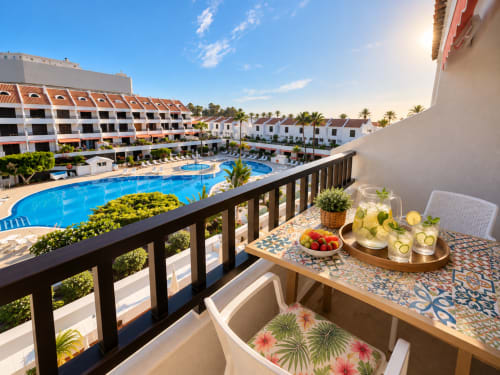 Balcony view at Manage Home Tenerife with pool, refreshments, and resort grounds in Playa de Las Americas