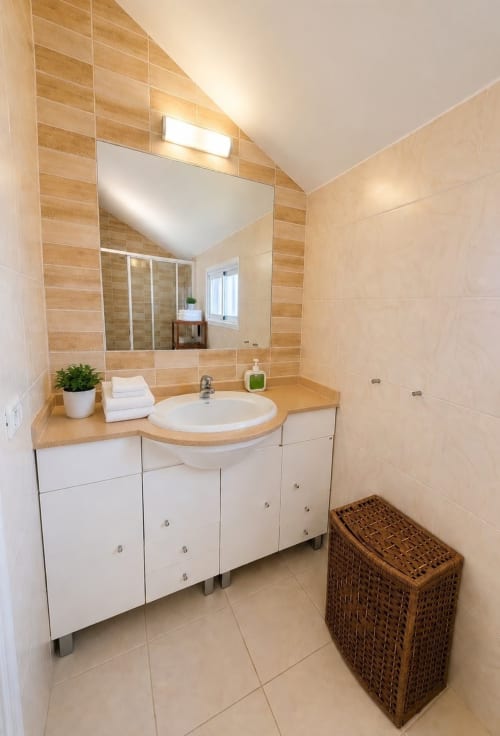 Modern bathroom in Manage Home Tenerife apartment with wooden tile accents, white vanity, round sink, and mirror in Playa de