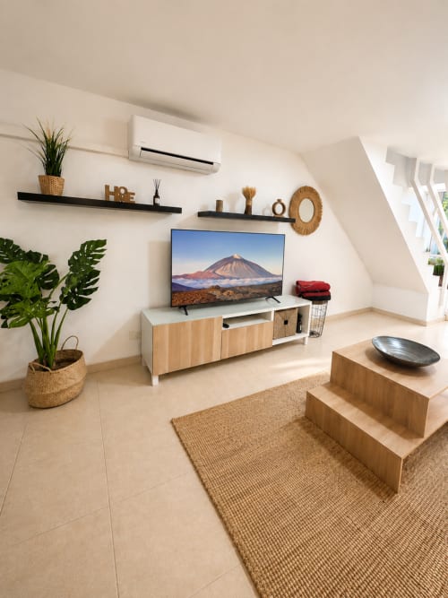 Modern living room in Duplex Michelle Parque Santiago I, Tenerife with flat-screen TV, wooden furniture, air conditioning,