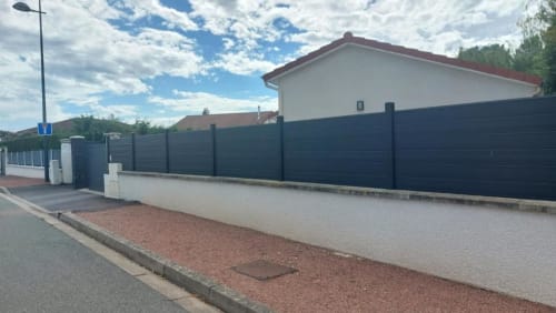 Résidence des Sables courtyard entrance in Mably with gated property, modern paved terrace, and residential building