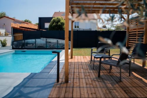 New York Apartment terrace at Résidence des Sables with heated swimming pool, wooden deck, pergola, and loungers overlooking