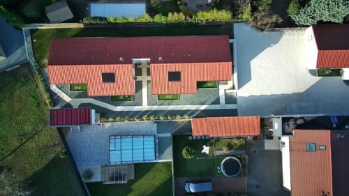 Aerial view of Résidence des Sables in Mably featuring red-roofed buildings, pool, courtyard, and surrounding greenery