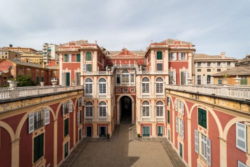 Affascinante cortile rinascimentale di La Superba Stay a Genova con facciate rosse e color crema