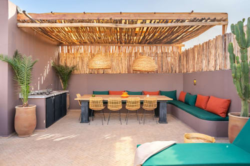 Terrasse sur le toit des M Résidences à Grasse avec pergola en bois, table à manger, coin salon et plantes en pot