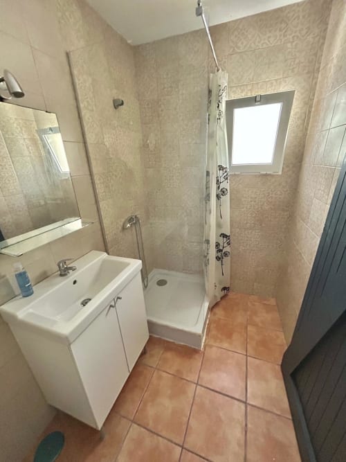Baño moderno en Apartamento Estereros Centro Jerez con ducha, lavabo, suelo de barro y azulejos decorativos
