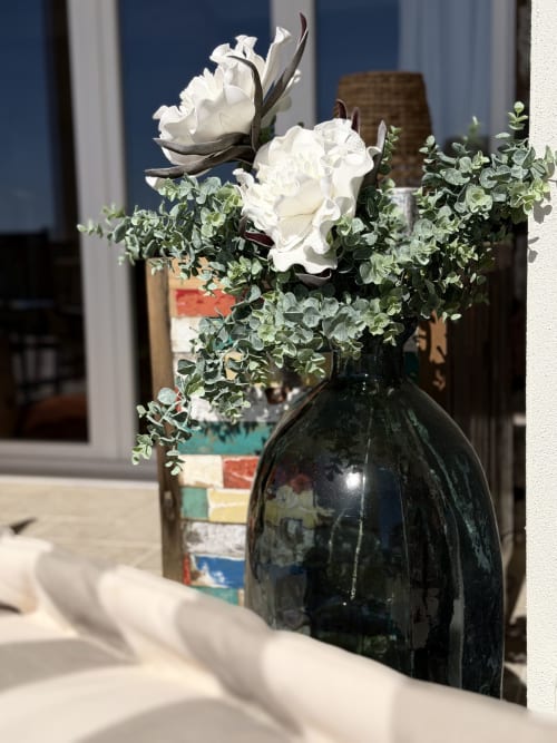 Roses blanches avec feuillage d'eucalyptus dans un vase noir à l'hôtel-boutique Petit Coin de Paradis, Alata