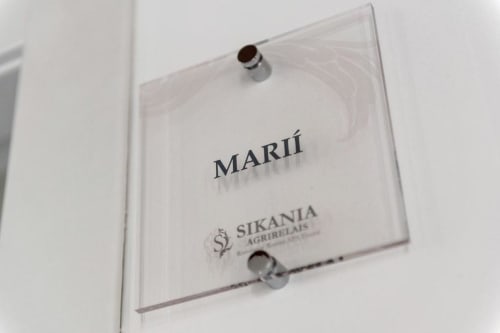 Sikania Agri Relais nameplate on glass door at Caccamo hotel room entrance