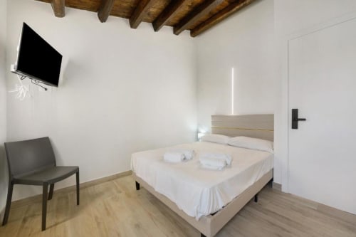 Modern SCHIETTA double room at Sikania Agri Relais in Caccamo with mountain view, wooden beams, and contemporary furnishings