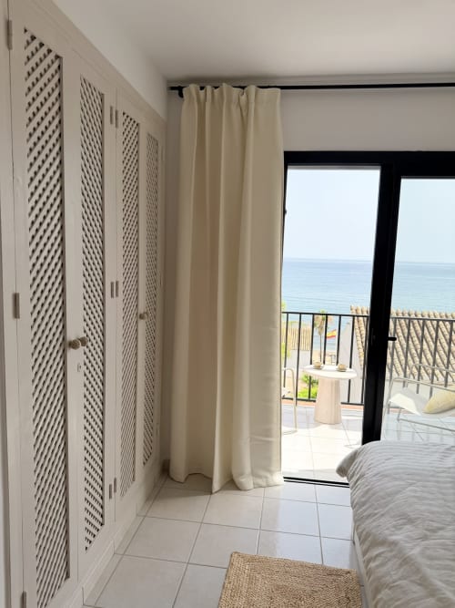 Bright bedroom with sea view doors opening to balcony overlooking Mediterranean at HomyMarbella Calahonda cottage
