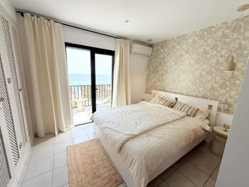 Bright seaview bedroom at HomyMarbella's Doña Lola townhouse with balcony overlooking Calahonda beach, cream furnishings and