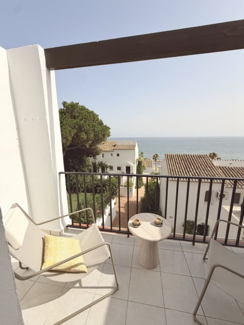 Seaside balcony with lounge chairs and sea view at HomyMarbella's Seaview Townhouse in Calahonda