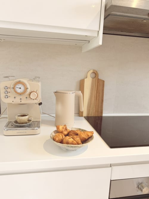 Modern kitchen setup with espresso machine, croissants, and milk pitcher at HomyMarbella Seaview Townhouse in Calahonda