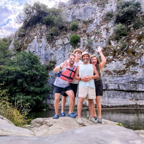 Four friends enjoy outdoor adventure by a cliff-lined river near Mes Maisons gîtes in South France