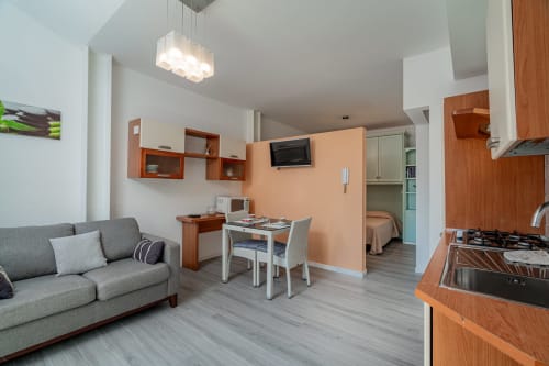 Modern studio apartment at Short Let's Olbia with open-plan living, kitchenette, dining area and bedroom space