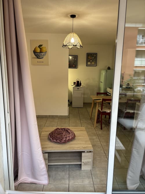 Cuisine moderne d'un appartement à Aix-en-Provence avec luminaire suspendu, coin repas et réfrigérateur vert rétro