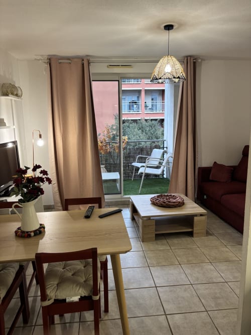 Séjour moderne à Aix-en-Provence avec vue sur la ville, table à manger et accès au balcon
