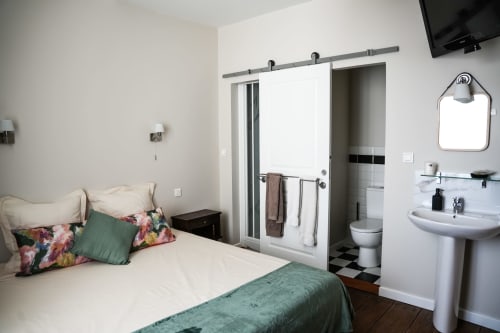 Le Saint Laurans hotel room in Aurignac with bed, ensuite bathroom, TV, and modern amenities
