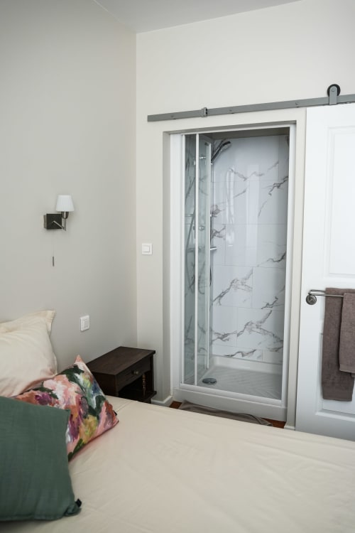 Modern ensuite shower with marble tiles in Chambre B at Le Saint Laurans hotel, Aurignac