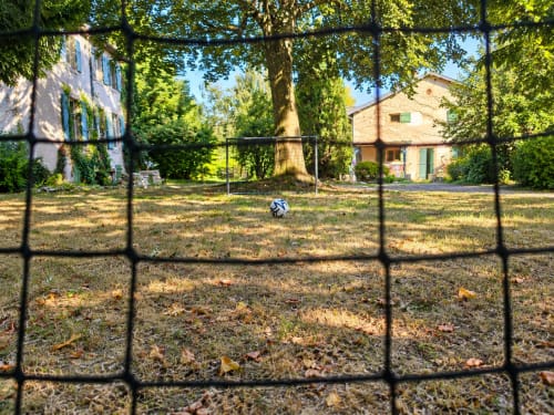 Soccer ball in grounds of Maison Agami, Rosières aux salines, with ivy-covered buildings and trees
