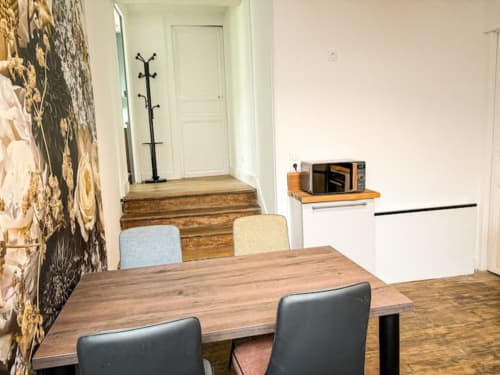 Espace de vie luxueux à La Demeure des Cyprès à Alençon avec table à manger et kitchenette moderne