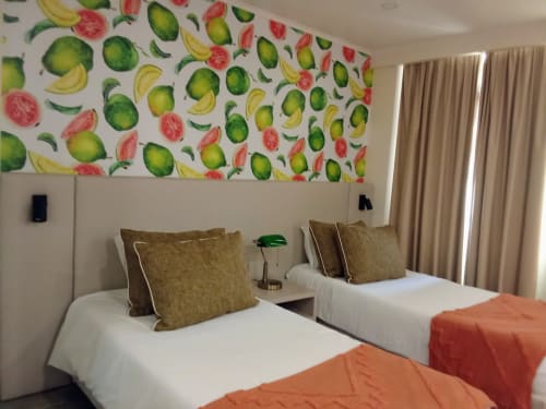 Twin beds with olive pillows in tropical-themed Goiaba apartment at Tropical Solutions, Funchal, featuring fruit wallpaper